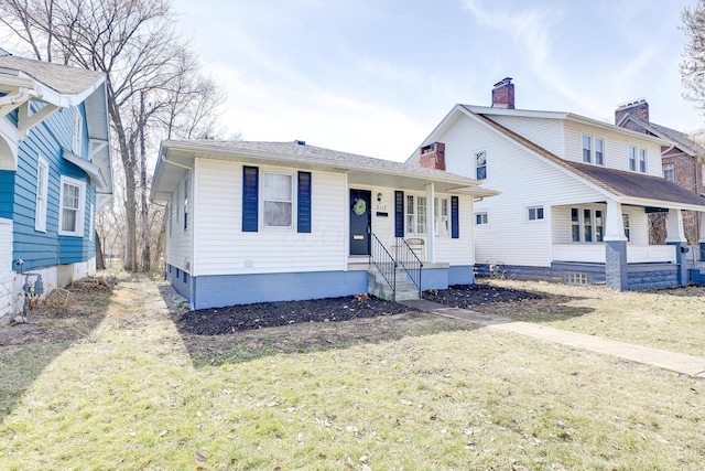 view of front of property featuring a front lawn and a chimney