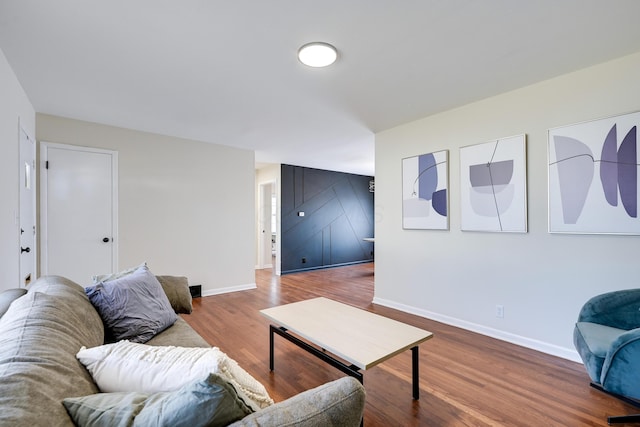 living area featuring baseboards and wood finished floors