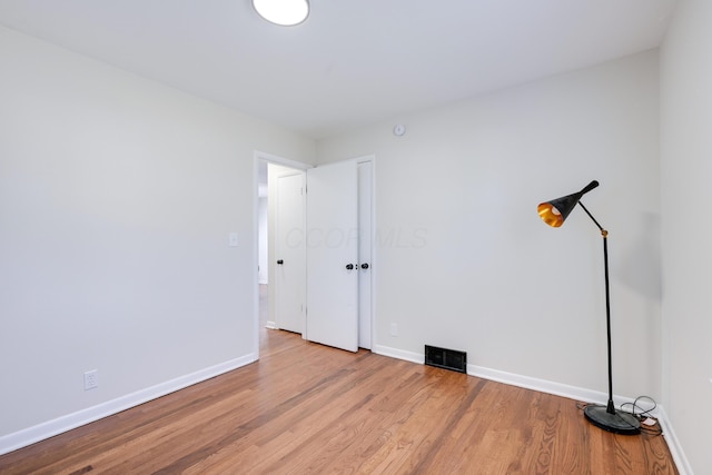 interior space featuring wood finished floors, visible vents, and baseboards