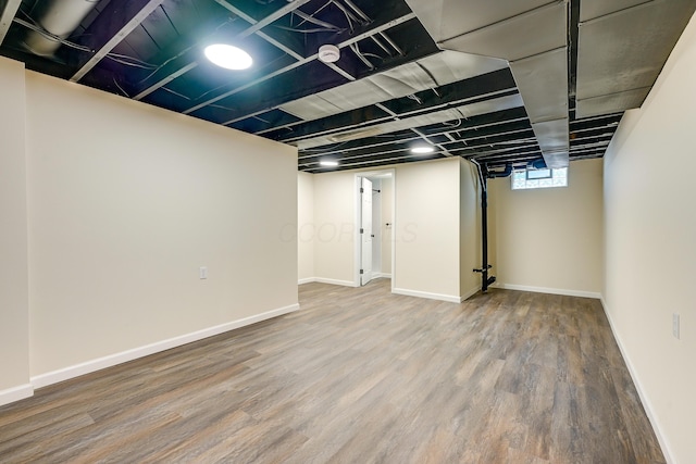 basement with wood finished floors and baseboards