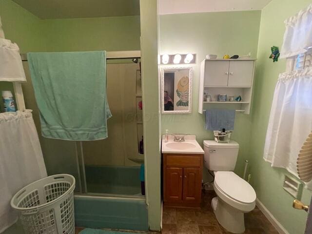 full bath with baseboards, toilet, vanity, and tile patterned flooring