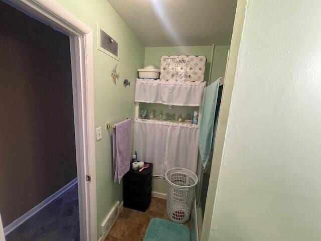 bathroom with tile patterned floors, visible vents, and baseboards