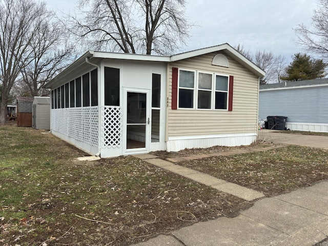 view of side of home featuring a sunroom