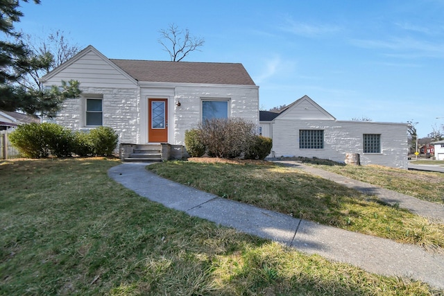 view of front of home with stone siding and a front lawn