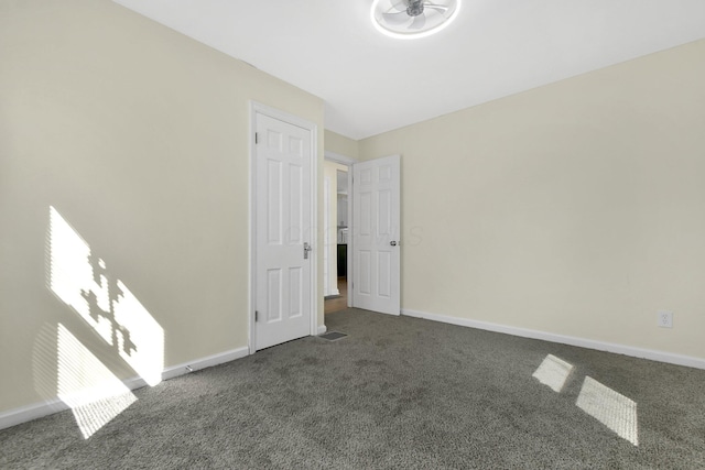 carpeted spare room featuring baseboards