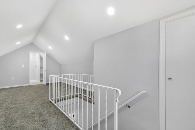 hallway featuring carpet, baseboards, lofted ceiling, recessed lighting, and an upstairs landing