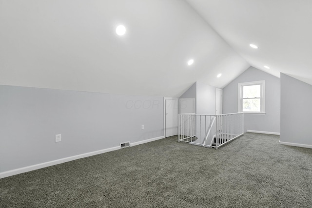 additional living space featuring lofted ceiling, carpet flooring, baseboards, and visible vents