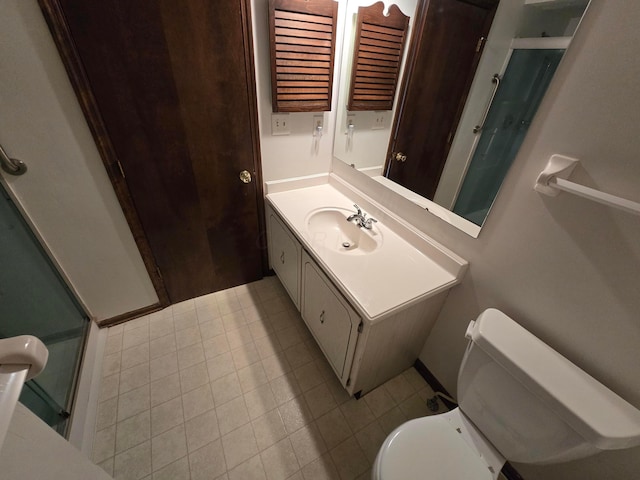 full bath featuring vanity, toilet, a shower stall, and tile patterned flooring