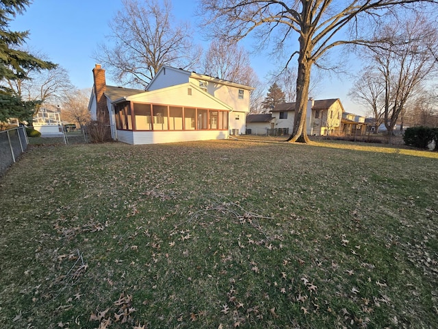 view of yard featuring fence private yard and a sunroom