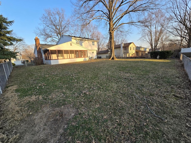 view of yard featuring a fenced backyard and a sunroom