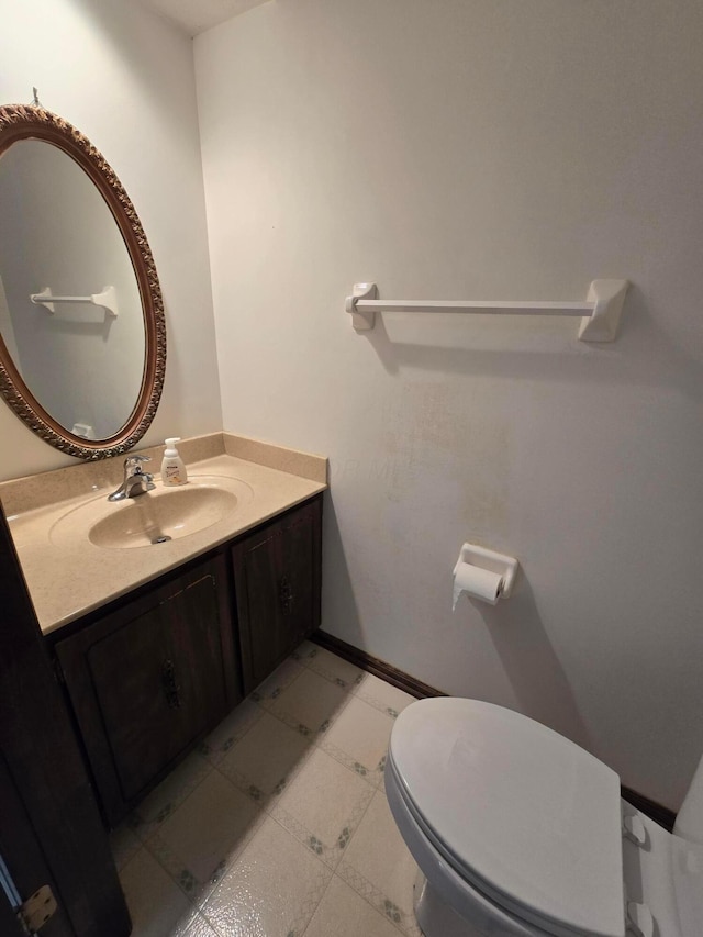 bathroom featuring vanity, tile patterned floors, and toilet