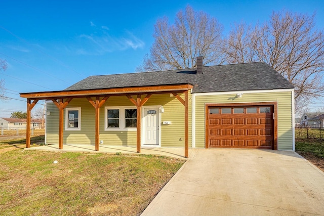 view of front of property with concrete driveway, a front yard, covered porch, a chimney, and an attached garage