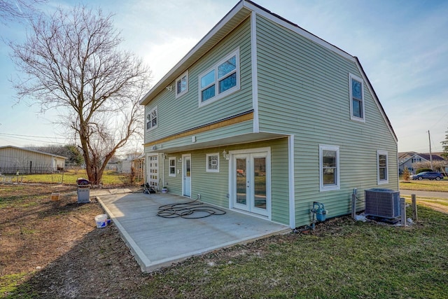 rear view of house featuring a patio area, central air condition unit, french doors, and fence