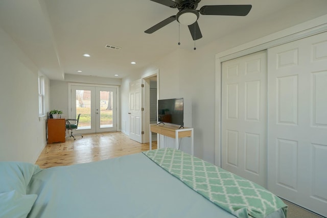 bedroom with wood finished floors, visible vents, recessed lighting, french doors, and access to outside