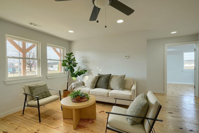 living area with recessed lighting, visible vents, a healthy amount of sunlight, and light wood finished floors