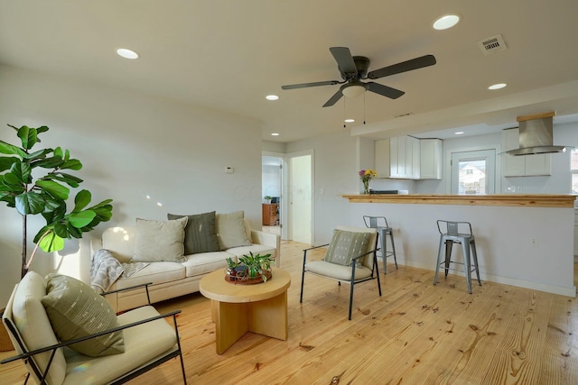 living area featuring recessed lighting, visible vents, ceiling fan, and light wood finished floors