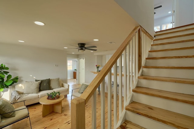 stairway with visible vents, recessed lighting, ceiling fan, and wood finished floors