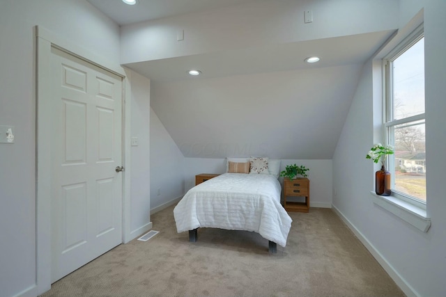 bedroom featuring light carpet, recessed lighting, lofted ceiling, and baseboards