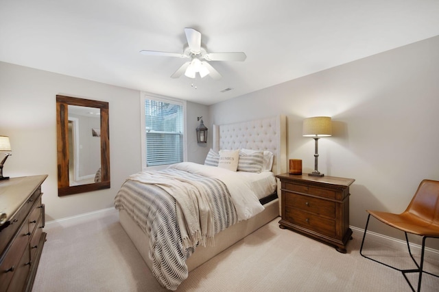 bedroom featuring a ceiling fan, baseboards, visible vents, and light carpet