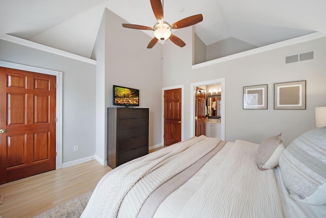 bedroom featuring visible vents, baseboards, light wood-type flooring, ensuite bath, and a ceiling fan