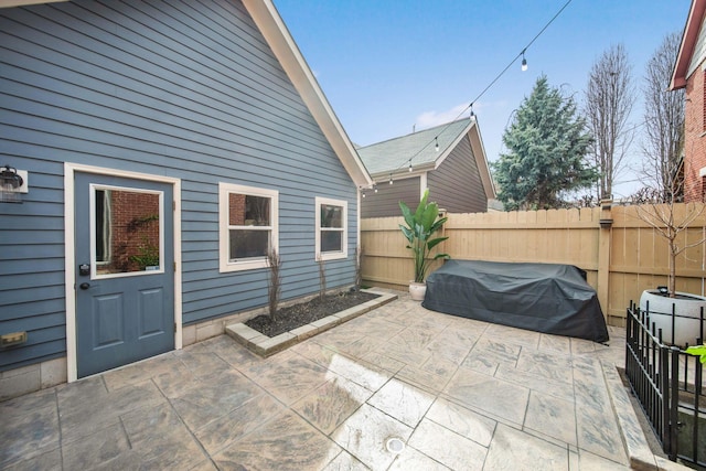 view of patio with grilling area and fence