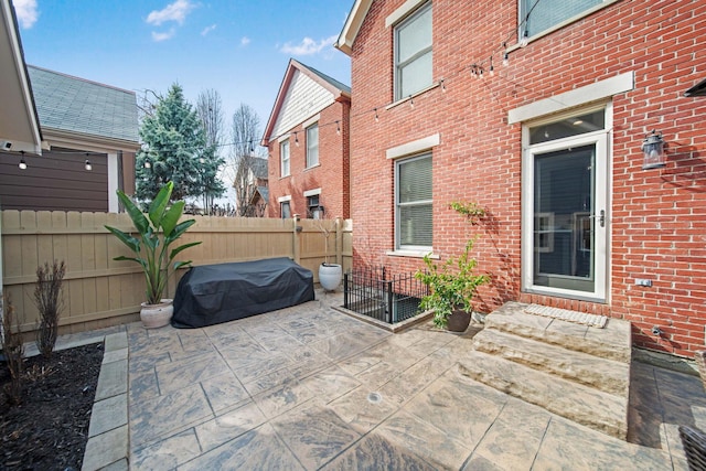 view of patio with grilling area and fence