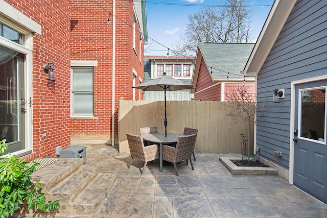 view of patio / terrace with outdoor dining space and fence