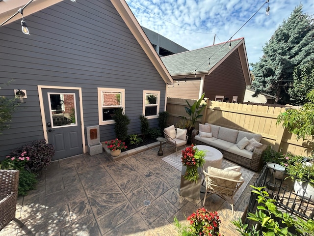 view of patio featuring an outdoor living space and fence