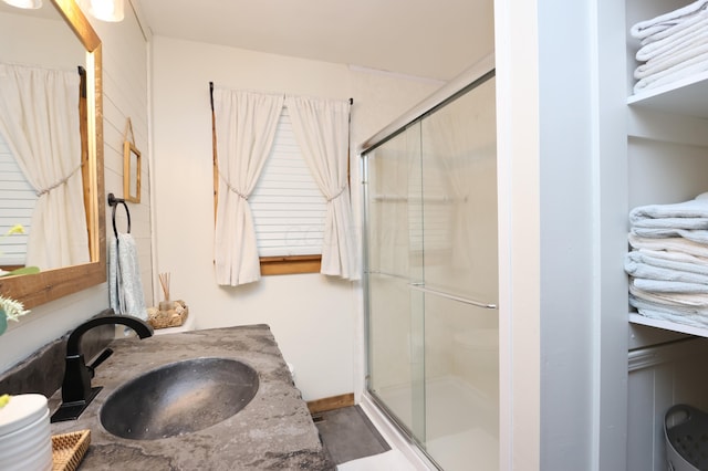 full bathroom featuring a shower stall, vanity, and toilet