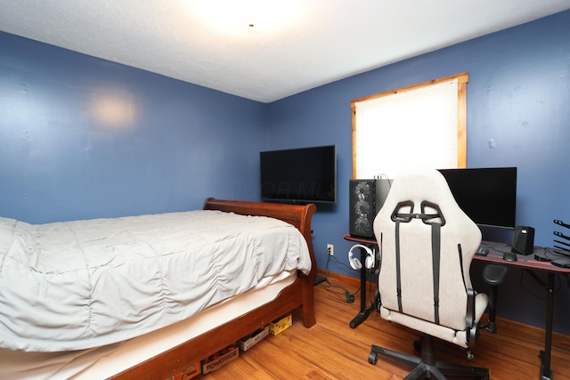 bedroom with wood finished floors