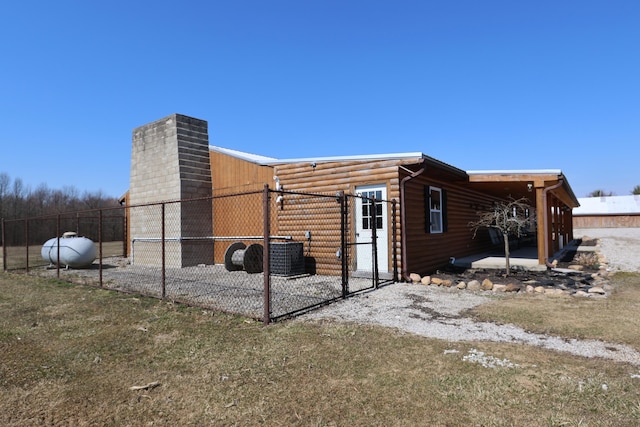 view of property exterior featuring faux log siding and fence