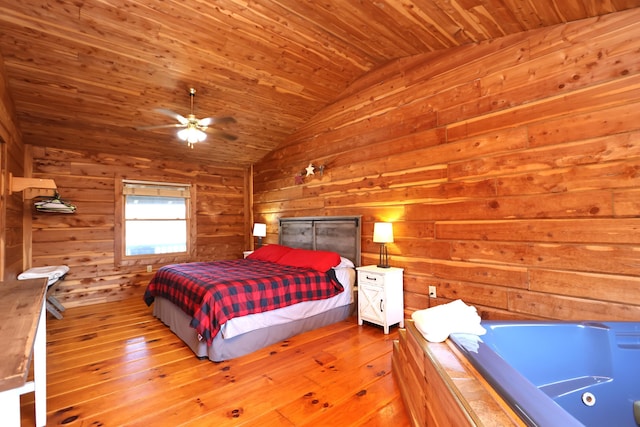 bedroom featuring vaulted ceiling, wooden walls, wood-type flooring, and wooden ceiling