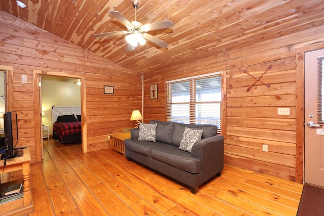 living area featuring light wood finished floors, wooden walls, ceiling fan, wood ceiling, and lofted ceiling