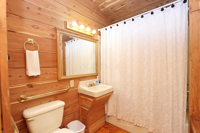 full bathroom featuring toilet, wood walls, wood ceiling, vanity, and vaulted ceiling