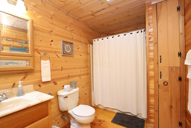 full bathroom with wooden walls, toilet, wood ceiling, and vanity