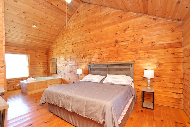 bedroom featuring hardwood / wood-style flooring, wooden ceiling, wooden walls, and vaulted ceiling