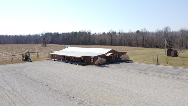 bird's eye view with a rural view and a wooded view