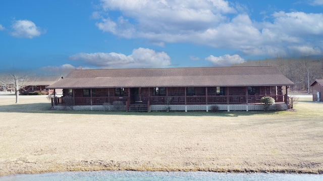 view of front of house featuring log exterior and covered porch