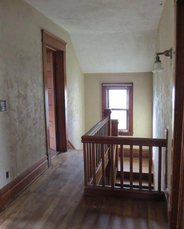 staircase featuring hardwood / wood-style floors and vaulted ceiling