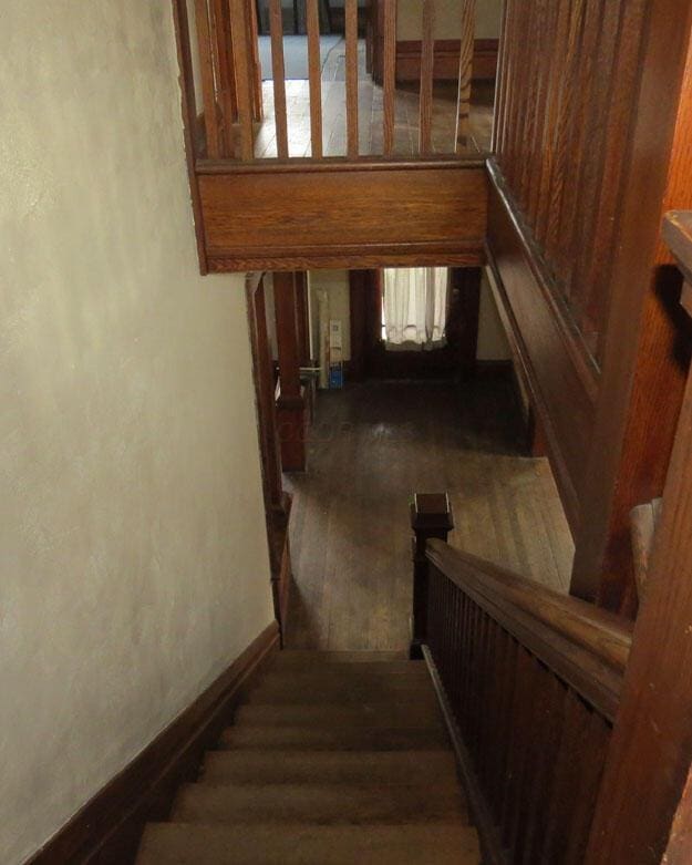 stairway with baseboards and wood finished floors