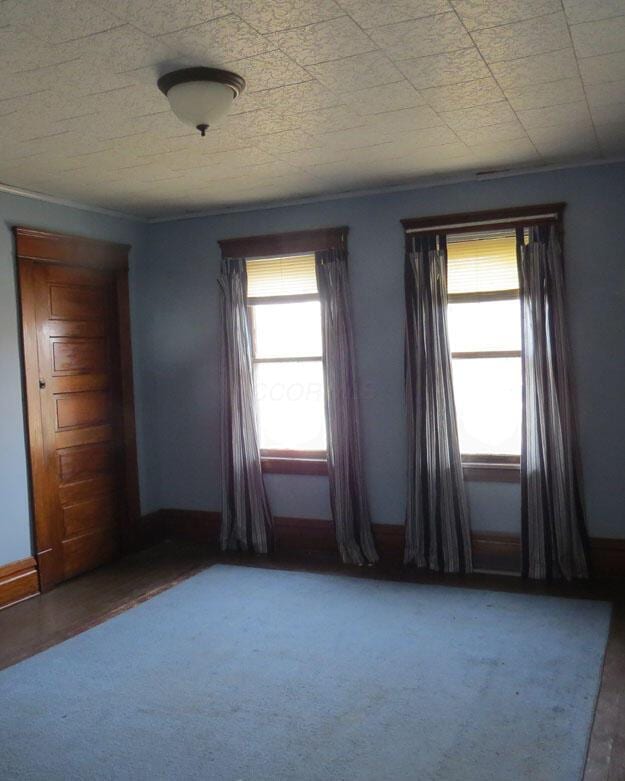 empty room featuring a healthy amount of sunlight and baseboards