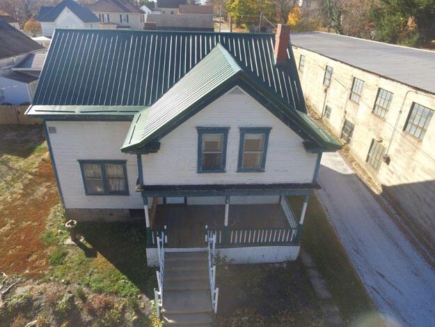 view of front of house featuring driveway and a chimney