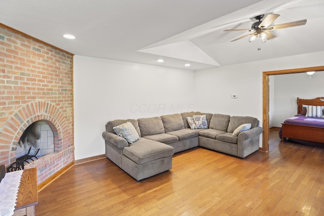 living room with recessed lighting, light wood-style flooring, ceiling fan, and vaulted ceiling