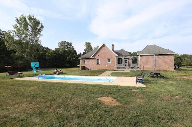 outdoor pool featuring a lawn and a patio area