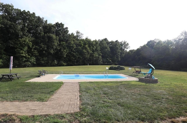 pool with a patio and a yard