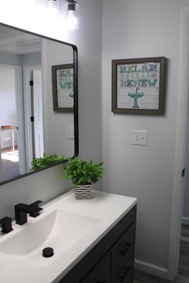 bathroom featuring vanity and baseboards