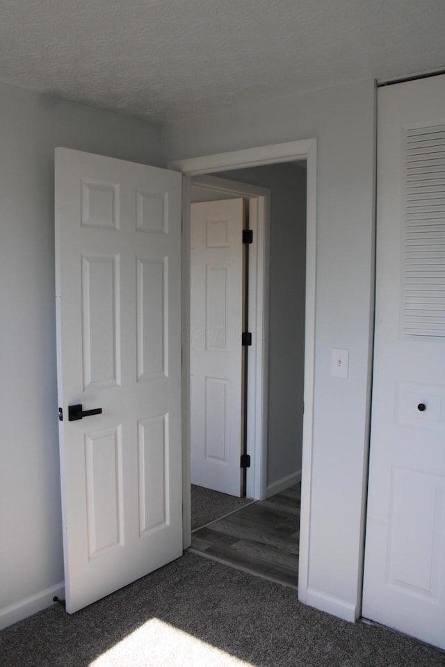 unfurnished bedroom featuring carpet flooring and baseboards