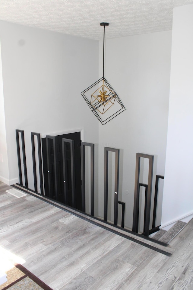 room details with wood finished floors, baseboards, and a textured ceiling