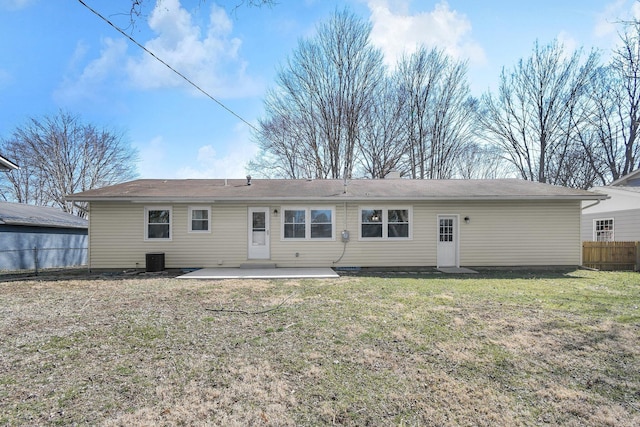 back of property with a patio area, central air condition unit, a lawn, and fence