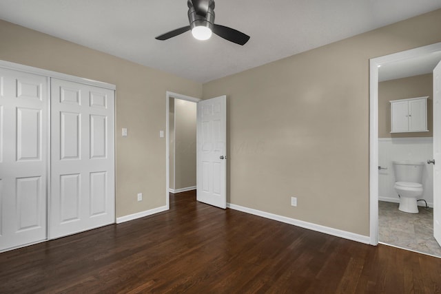 unfurnished bedroom featuring wood finished floors, baseboards, ensuite bath, ceiling fan, and a closet